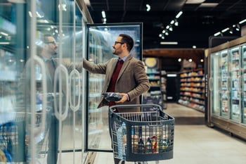 Person in a grocery store aisle making a decision