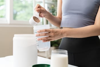 Person making protein shake 