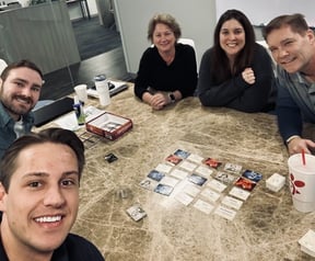 Team members playing card games during Have Fun at Work Day