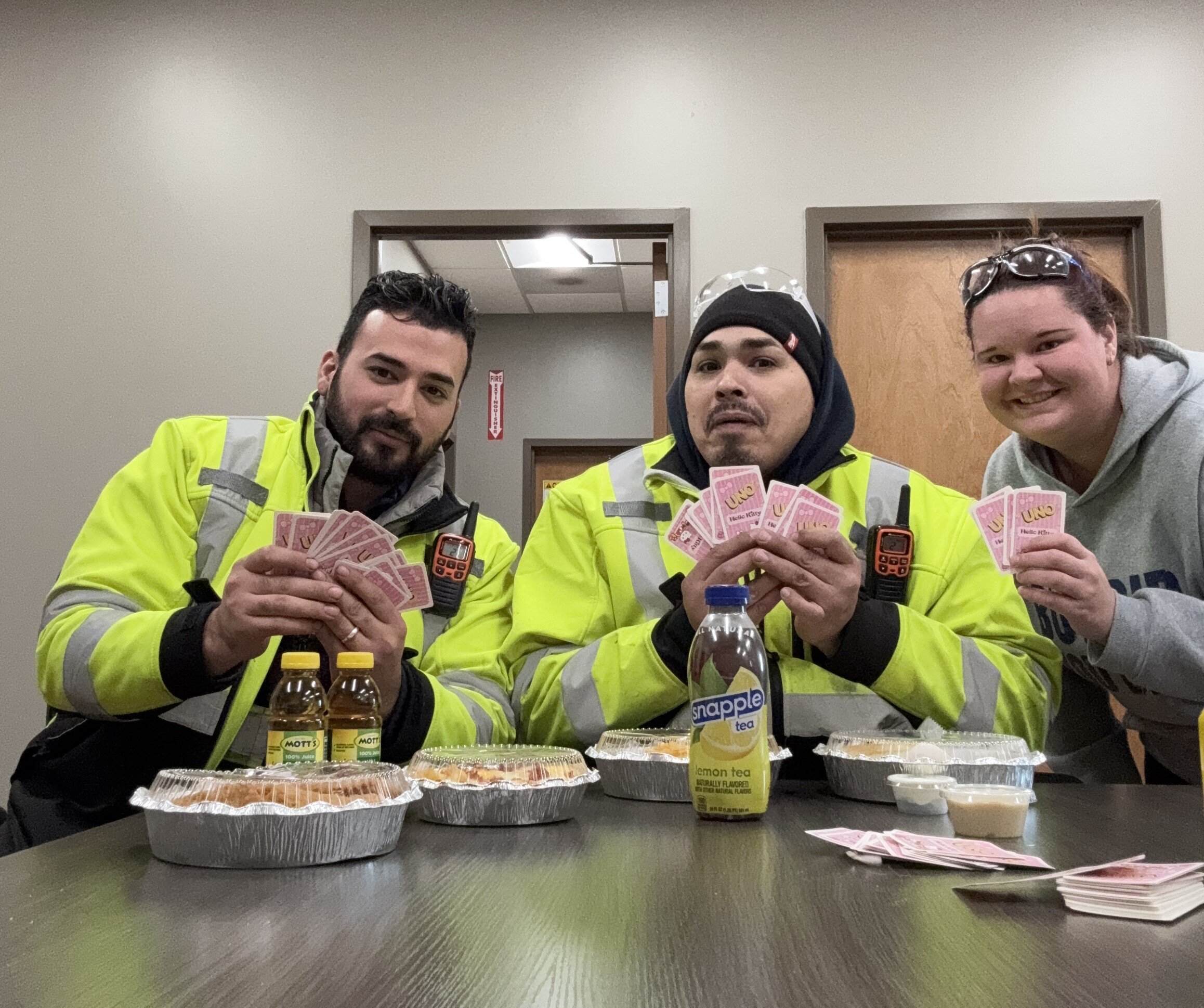 Team members taking a break to play card games during Have Fun at Work Day